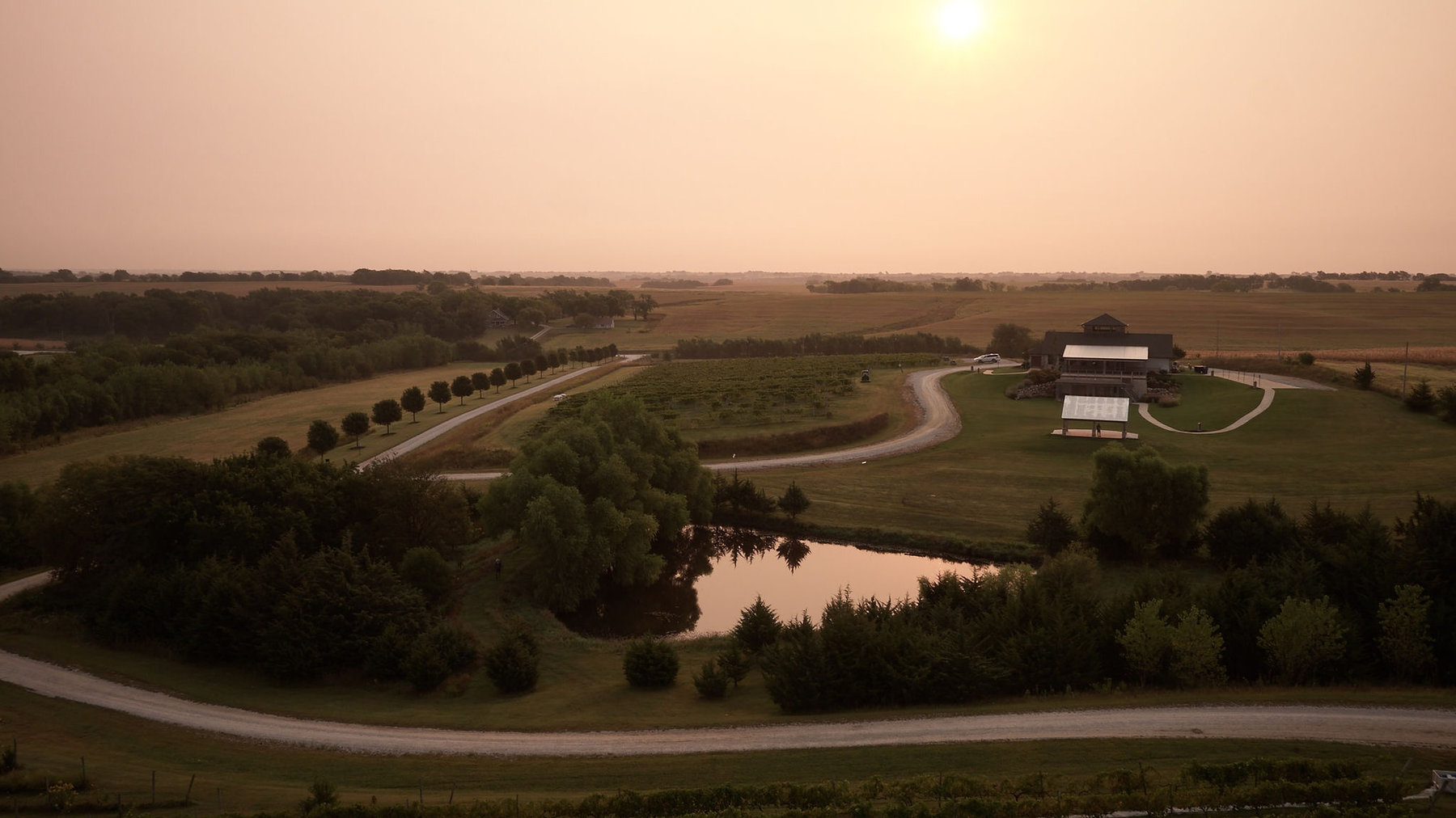 Sunset over the ponds and rolling landscape at Glacial Till Vineyard